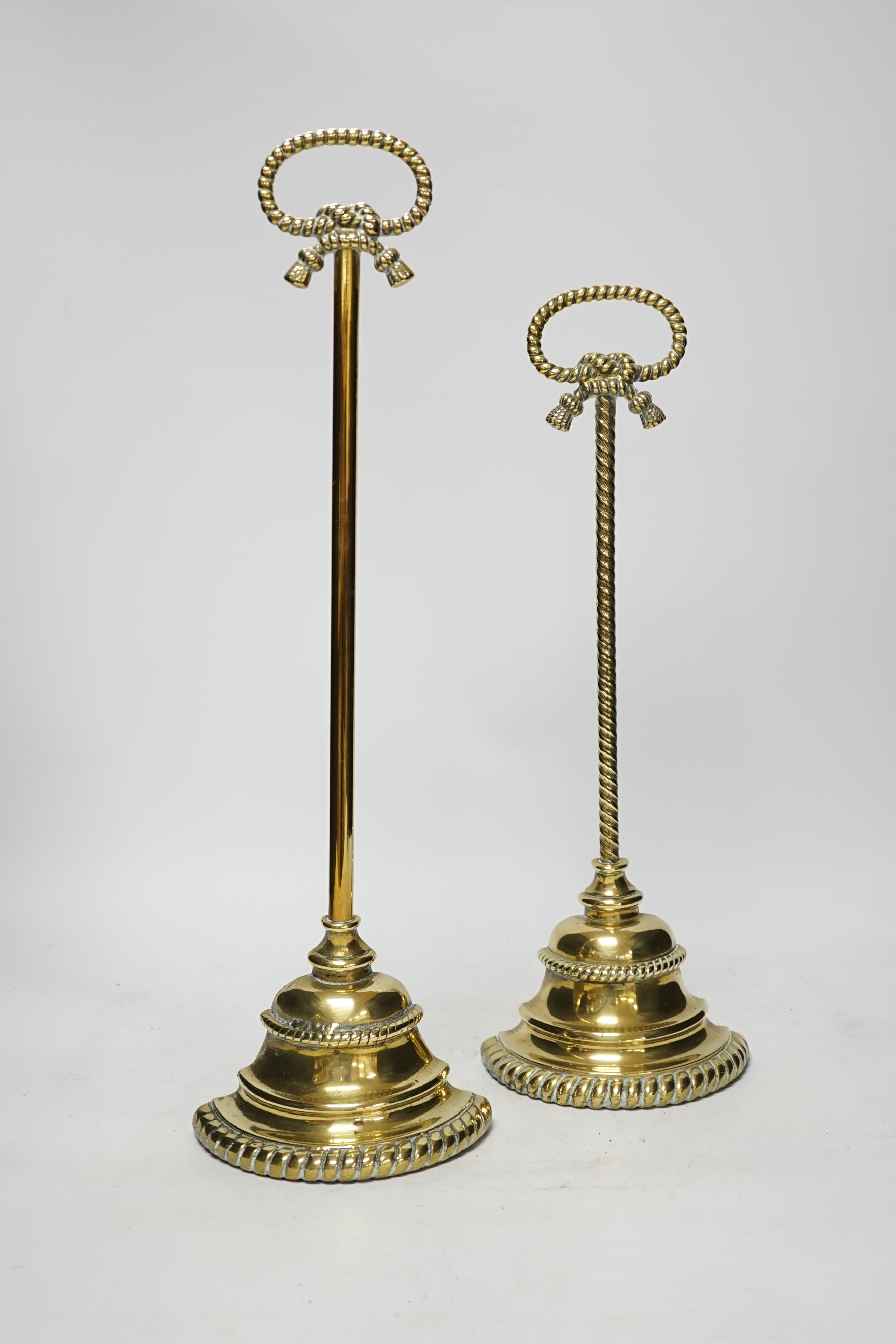 Two early 19th century cast brass door stops, with gadrooned edged plinths, tallest 50cm high